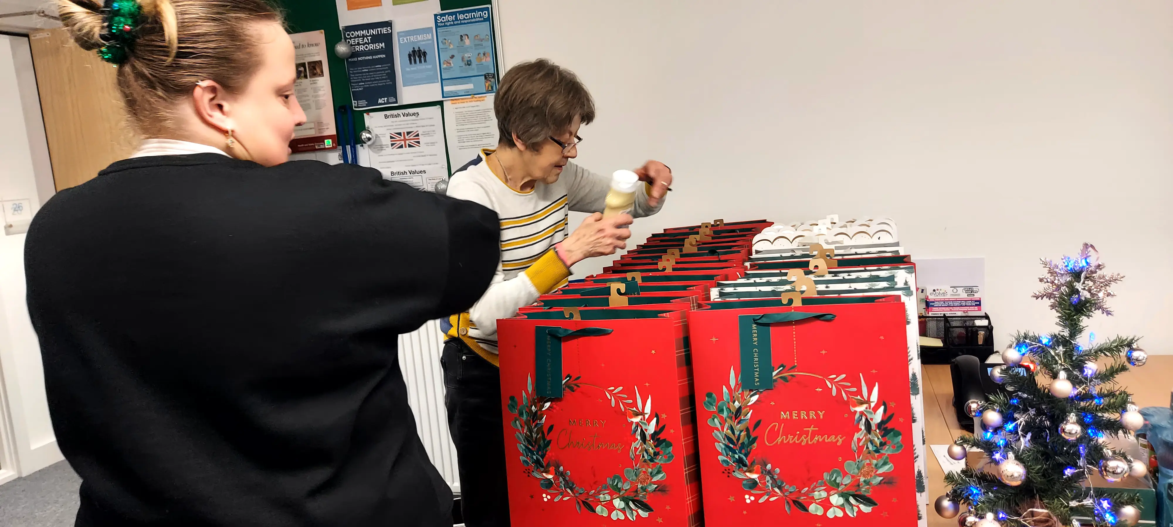 Volunteers preparing Christmas gift bags